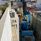 Delivery of e hotttub using a crane in a small one way street at the Algarve.